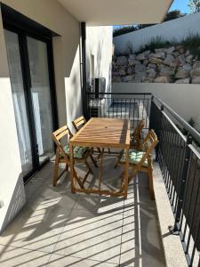 a wooden table and two chairs on a balcony at Suarina in Porto-Vecchio
