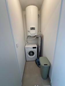 a small bathroom with a washing machine and a dryer at Suarina in Porto-Vecchio
