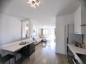 a kitchen and living room with a table and a couch at Attico di Cesare Luxury Piazza Anfiteatro Lucca in Lucca