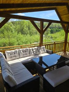 a living room with a couch and a table on a deck at Kasi Polany in Polany