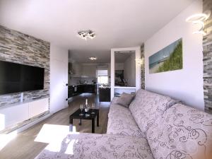 a living room with a couch and a table at Attico di Cesare Luxury Piazza Anfiteatro Lucca in Lucca +28 photos