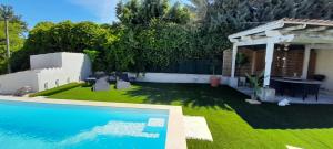 a backyard with a swimming pool and a house at L'olivier TESSA Hôtesse suite 30m2 terrasse 20m2 in La Celle