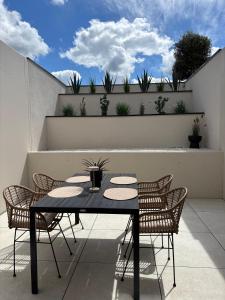 a table and chairs on a patio with plants at Moderne Ferienwohnung Ravensburg in Ravensburg