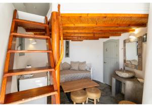 a room with a bunk bed and a desk at WindMilos in Tripiti +40 photos