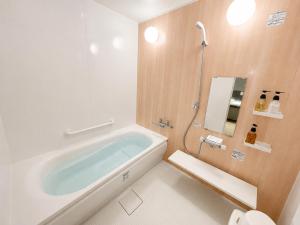 a bathroom with a bath tub and a toilet at Volcano in Kagoshima