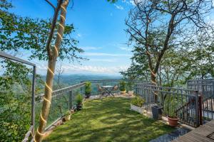 a balcony with a bench and a view of the mountains at Oak Villa in Dharampur