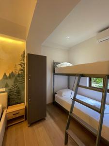 a room with a bunk bed and a bedroom with a ladder at Bora Hotel in Gjirokastër +41 photos