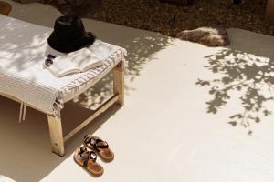 a hat and a book on a table with a pair of shoes at Le Cabanon de Val in Gassin +33 photos