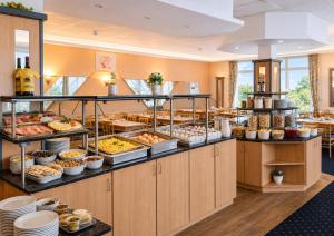a buffet line with many different types of food at Sporthotel Middelpunkt in Aurich