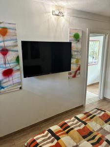 a flat screen tv hanging on a wall at Guest House Persico in Desenzano del Garda