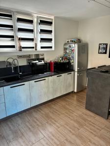 a kitchen with a stainless steel refrigerator and cabinets at Guest House Persico in Desenzano del Garda