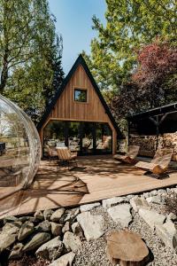 a wooden deck with a glass dome next to a house at Maroska Pine in Kismaros