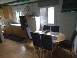 a kitchen with a table and chairs and a refrigerator at Jack House in Mostec