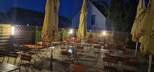 a group of tables and chairs with yellow umbrellas at Gasthof Kirchberger in Fürth