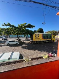 a truck parked in a parking lot with cars at Pousada Oliveira in Cachoeira