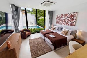 a bedroom with a bed and a living room at Botanica Foresta Luxury Villa Phuket in Phuket +42 photos