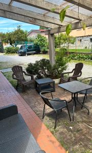a group of chairs and a table and a picnic table at Guest House Persico in Desenzano del Garda