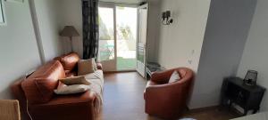 a living room with two chairs and a couch at L'olivier TESSA Hôtesse suite 30m2 terrasse 20m2 in La Celle