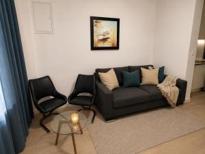 a living room with a couch and two chairs at Perello Old Town in Split