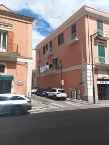 a street with cars parked in front of a building at Dimora in pieno centro in Matera