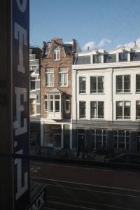 a view of some buildings from a window at Hotel Sphinx in Amsterdam