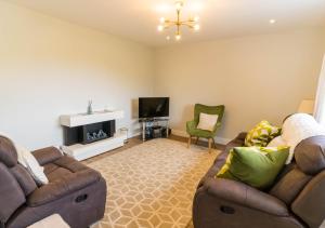 a living room with two couches and a television at Carhan House - Cahersiveen in Cahersiveen