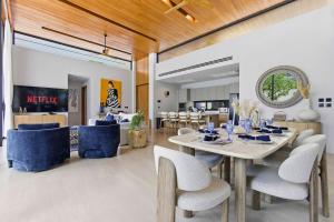 a dining room with a table and chairs at Botanica Foresta Luxury Villa Phuket in Phuket