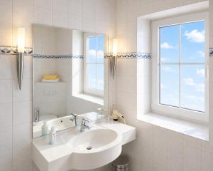 a white bathroom with a sink and a window at Sporthotel Middelpunkt in Aurich +15 photos