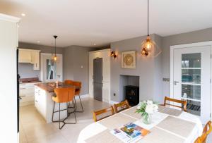a kitchen and living room with a table and chairs at Carhan House - Cahersiveen in Cahersiveen