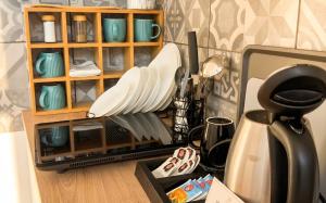 a kitchen counter with plates and utensils at Mekcsey Udvar in Eger