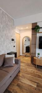 a living room with a couch and a table at Mini loft moderno di fronte Zoomarine in Torvaianica