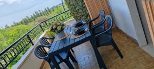 a wooden table and chairs on a balcony at Mini loft moderno di fronte Zoomarine in Torvaianica