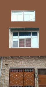 two windows on top of a brick building at Shivansh Homestay in Mathura