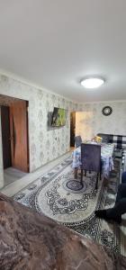 a living room with a table and a rug at Ganja Apart in Ganja +15 photos