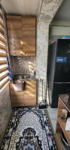a kitchen with a sink and a kitchen rug at Ganja Apart in Ganja