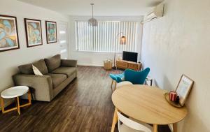 a living room with a couch and a table at Sea Breeze with City Ease in Port Lincoln