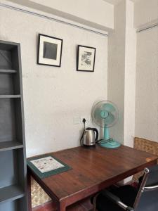 a wooden table with a lamp on top of it at Davu Gallery Cafe in Kathmandu