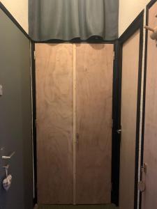 a sliding door in a bathroom with a curtain at Bouquetin studio cosy in Notre-Dame-de-Bellecombe