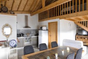 a kitchen and dining room with a table and chairs at Casa Saudade Vila Real North in Vila Real