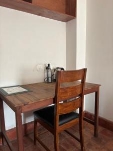 a wooden table with a chair and a coffee maker at Tehra Family Building in Kathmandu