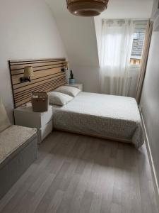 a bedroom with two beds and a wooden floor at Appartement central - ORLEANS in Orléans