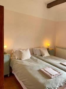 two beds sitting next to each other in a bedroom at Borgo Belsedere - biofarm estate resort in Tuscany in Trequanda