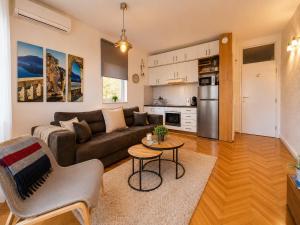 a living room with a couch and a table at Apartments Inspiration in Budva