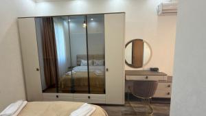 a bedroom with a mirror and a bed and a sink at Green House Marina in Batumi +33 photos