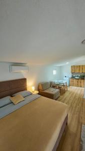 a bedroom with a large bed and a table at JazAzur in Lastva