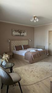 a bedroom with a large bed and a chair at Вершина in Pilipets