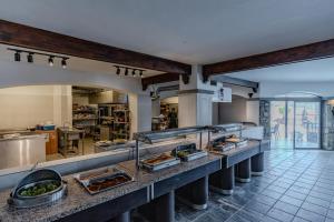 a kitchen with a bunch of food on a counter at Mira Beach Resort Bodrum - All inclusive in Bodrum City