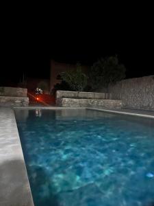 a swimming pool in a yard at night at Dar Joud Kaouki in Sidi Kaouki +64 photos
