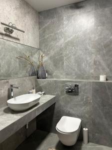 a bathroom with a white toilet and a sink at Вершина in Pilipets +20 photos