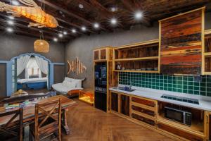 a kitchen with wooden cabinets and a dining room at Little Sun Homestay - Free Buggy Tour check-in Sunset Town in Phú Quốc